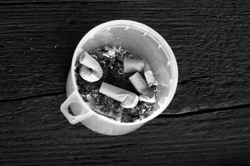 Close-up of cigarette butts from cigarettes in a plastic cap