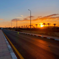 beautiful red-orange sunset on the roadway of the city of Sharm el-Sheikh in Egypt