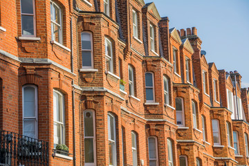Windows of red brick mansion houses in London