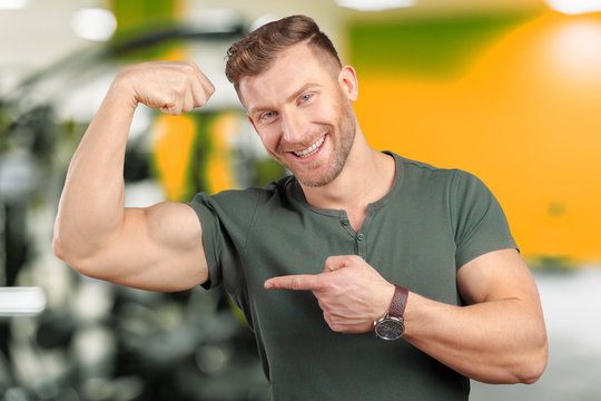 Smiling Man Showing Biceps