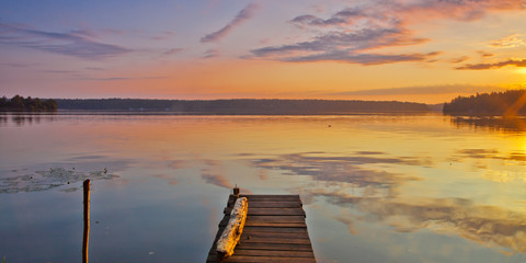 Beautiful distances. Quiet lake. Orange - a blue lake landscape.
