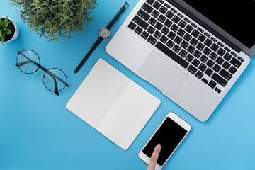 Social network connecting office table concept with fashion accessories, minimal interior with a woman holding smartphone, top view, flat lay, mockup, copy space