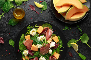 Parma ham and melon salad with mozzarella, green leaves mix