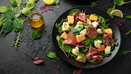 Parma ham and melon salad with mozzarella, green leaves mix