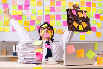 Young employee in conflicting priorities concept 