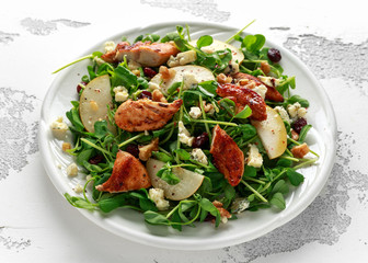Pear, chicken salad with blue cheese, cranberry and walnuts. concept healthy food
