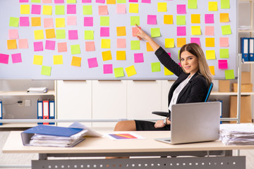 Young beautiful businesslady in conflicting priorities concept 