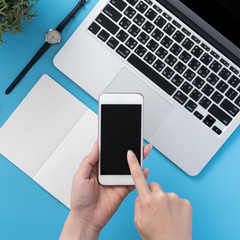 Social network connecting office table concept with fashion accessories, minimal interior with a woman holding smartphone, top view, flat lay, mockup, copy space