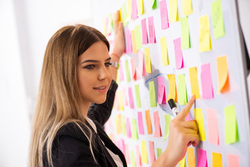 Young beautiful businesslady in conflicting priorities concept 