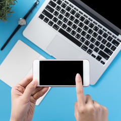 Social network connecting office table concept with fashion accessories, minimal interior with a woman holding smartphone, top view, flat lay, mockup, copy space