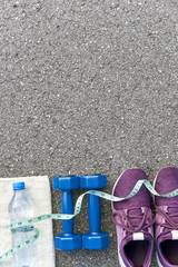 Naklejka premium Measure tape covers sports items and bottle of water.