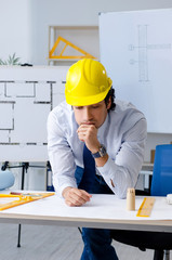 Young handsome architect working on the project 