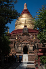 Fototapeta na wymiar THe golden spire of the Dhamma ya Zeka Pagoda, Bagan, Myanmar