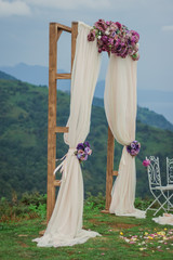 Beautiful wedding arch in the mountains, decoration for wedding ceremony