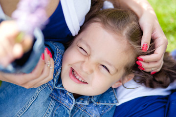 the girl lies in her mother's arms
