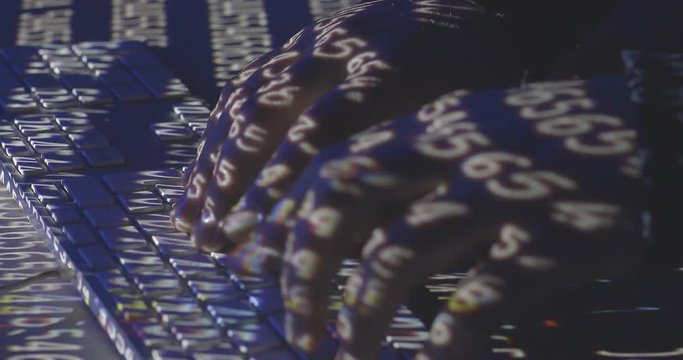 Hands of hacker writes code on the keyboard