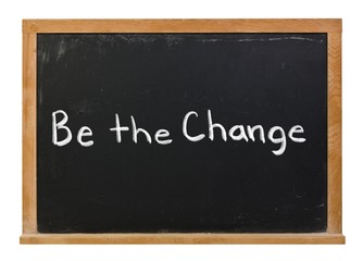 Obraz premium Be the change written in white chalk on a black chalkboard isolated on white
