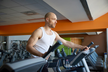 Fototapeta na wymiar Man doing cardio training on treadmill