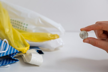 Fototapeta na wymiar 0.25 Turkish lira and plastic bag on the background. hand hold money with grocery sack