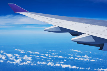 View of cumulus clouds and blue sky from airplane