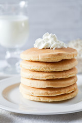 Fototapeta na wymiar Stack Of Pancakes With Whipped Cream
