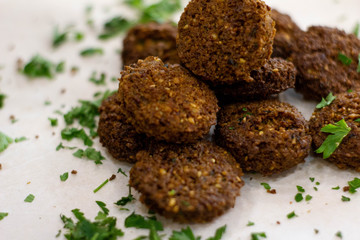 Fresh falafel with greens on white background