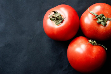 fresh tomatoes on black background