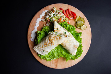 Shawarma sandwich with ingredients on dark background. Top view. sandwich in pita bread. burrito