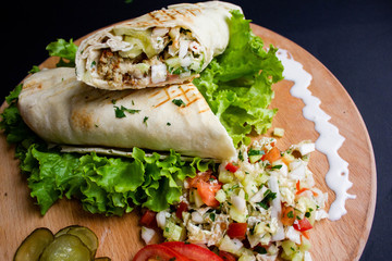 Shawarma sandwich with ingredients on dark background. Top view. sandwich in pita bread. burrito