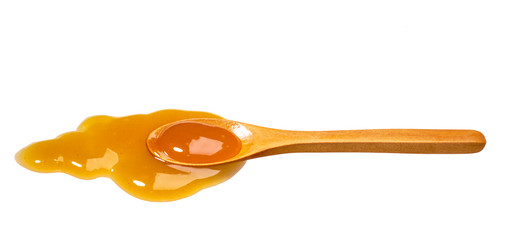 Orange sweet and sour sauce in small wooden spoon isolated on white background,