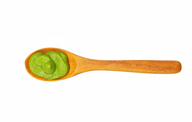 Wasabi sauce in small wooden spoon isolated on white background,top view