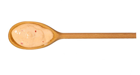 Paprika sauce   in wooden spoon isolated on white background,top view