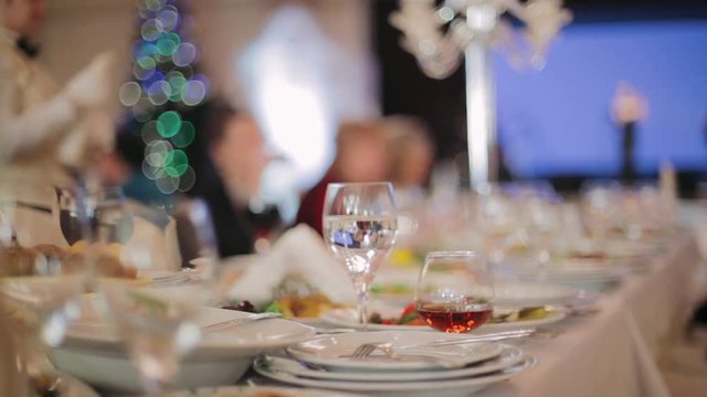 Waiters served festive table in the restaurant.