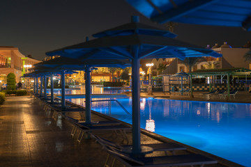 luxury resort with pool at night view. hotel outdoor landscape with pool. Night pool side of rich hotel.