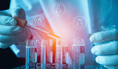 Researcher with glass laboratory chemical test tubes with liquid for analytical , medical, pharmaceutical and scientific research concept.