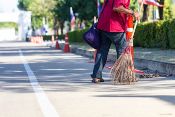 Man cleaning garbage on the road