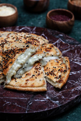 Turkish pizza served on the vooden plate