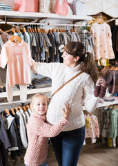 Family in baby’s cloths shop