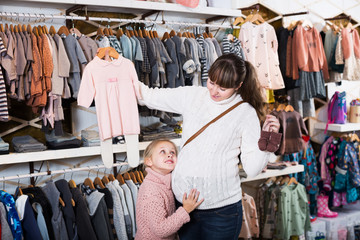 Fototapeta na wymiar Family in baby’s cloths shop