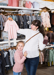 Family in baby’s cloths shop