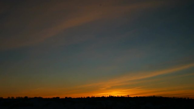 Landscape with the sunset. Orange enlightened cloud clouds and dark landscape. Seamless cinemagraph video