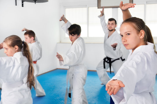 Children trying martial moves in karate class