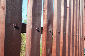 Wooden plank fence on blue sky background