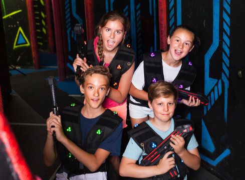 Girls and boys posing with laser pistols