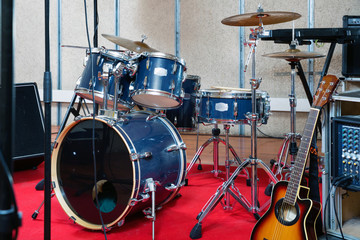 Fototapeta na wymiar Set of musical instruments ready for rehearsal of music band in modern sound studio