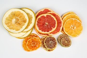 mix of different pieces of dried citrus fruit on white background