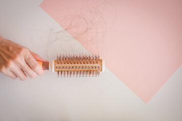 hair fall and lost alopecia woman problem on the comb.