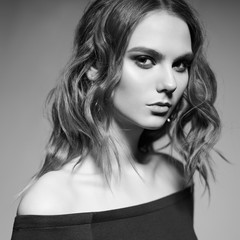Fashion portrait of young lady in black dress
