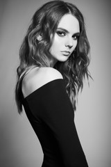 Fototapeta premium Fashion portrait of young lady in black dress
