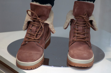 closeup of brown boots in fashion store showroom for women